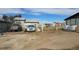 Spacious outdoor area showcasing vehicle parking, fence, and a barn-style building, ideal for rural living at 15600 E 33Rd Pl, Aurora, CO 80011