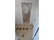 Hallway showing tile flooring and a staircase to a lower level at 15600 E 33Rd Pl, Aurora, CO 80011
