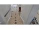 Staircase with new tile flooring and contrasting wall colors at 15600 E 33Rd Pl, Aurora, CO 80011