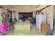 Horse stall interior featuring hay, chairs, and equipment, providing a glimpse into equestrian facilities at 15600 E 33Rd Pl, Aurora, CO 80011