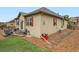 Back exterior featuring patio seating, lawn area and rock landscaping at 22466 E Layton Cir, Aurora, CO 80015