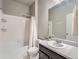 Bathroom featuring white tiled walls, vanity and a bathtub with a shower at 22466 E Layton Cir, Aurora, CO 80015