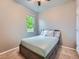 A carpeted bedroom with a ceiling fan and a bright window at 22466 E Layton Cir, Aurora, CO 80015