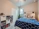 Cozy carpeted bedroom with a ceiling fan, natural light and a fun headboard at 22466 E Layton Cir, Aurora, CO 80015