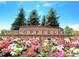 Inviting community entrance sign surrounded by colorful flowerbeds, trees, and landscaped grounds at 22466 E Layton Cir, Aurora, CO 80015
