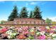 Landscaped community entrance featuring a colorful flower bed and stone signage reading 'Copperleaf' at 22466 E Layton Cir, Aurora, CO 80015