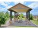 Charming community pavilion featuring picnic tables, stone pillars, and a well-maintained brick patio and landscaping at 22466 E Layton Cir, Aurora, CO 80015