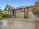 Beautiful two-car garage home exterior featuring stone accents, a basketball hoop, and a well-kept driveway at 22466 E Layton Cir, Aurora, CO 80015