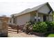Charming side view of a home featuring stone accents, a well-maintained yard, and a wooden fence at 22466 E Layton Cir, Aurora, CO 80015