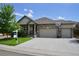 Charming single-Gathering home boasts a stone and vinyl facade, two-car garage, and well-maintained front yard at 22466 E Layton Cir, Aurora, CO 80015