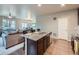 Kitchen area with large island, open layout, hardwood floors, and stainless steel appliances at 22466 E Layton Cir, Aurora, CO 80015