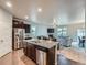 Open kitchen featuring granite countertops, stainless steel appliances, and hardwood flooring at 22466 E Layton Cir, Aurora, CO 80015