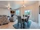Open-concept living room and dining area with stylish furniture and natural light at 22466 E Layton Cir, Aurora, CO 80015