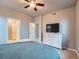 Neutral main bedroom with ceiling fan, white dresser and television at 22466 E Layton Cir, Aurora, CO 80015