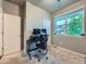 Office space featuring a dark desk, computer, and a large window at 22466 E Layton Cir, Aurora, CO 80015