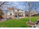 Spacious backyard featuring a well-maintained lawn and a covered patio at 11274 W 54Th Ln, Arvada, CO 80002