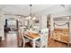 Cozy dining area features a classic table set, hardwood floors, and views into the living room at 11274 W 54Th Ln, Arvada, CO 80002