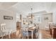 Cozy dining area features a classic table set, hardwood floors, and views into the living room at 11274 W 54Th Ln, Arvada, CO 80002