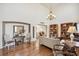 Inviting living room with hardwood floors, a decorative archway, and ample natural light at 11274 W 54Th Ln, Arvada, CO 80002