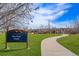 Skyline Park features a paved trail leading to a grassy area with playground equipment at 11274 W 54Th Ln, Arvada, CO 80002