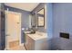 Bathroom with dual sinks, updated fixtures, and blue walls at 1599 S Telluride St, Aurora, CO 80017