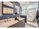 Modern bathroom features dual sinks, stylish mirrors, and a luxurious marble shower with a soaking tub at 1599 S Telluride St, Aurora, CO 80017
