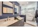 Bathroom featuring a double sink, shower and bathtub with marble walls at 1599 S Telluride St, Aurora, CO 80017