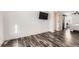 Bedroom featuring wood floors, a TV, and a door to another area at 1599 S Telluride St, Aurora, CO 80017