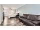 Spacious bedroom featuring wood floors, a comfortable bed, and a large leather couch at 1599 S Telluride St, Aurora, CO 80017