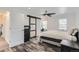 Spacious bedroom features an attractive ceiling fan, with stylish barn door to the walk-in closet at 1599 S Telluride St, Aurora, CO 80017