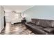 Relaxing bedroom with a large leather sofa and hardwood floors, offering ample space for relaxation at 1599 S Telluride St, Aurora, CO 80017