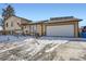 Inviting two-story home showcasing a two car garage, partial brick facade and covered front porch with a charming design at 1599 S Telluride St, Aurora, CO 80017