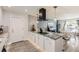 Kitchen boasts stone counters, stainless appliances, modern range hood, bar stool seating and mosaic backsplash at 1599 S Telluride St, Aurora, CO 80017