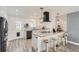 Bright kitchen features modern appliances, a central island with seating, and stylish backsplash tiles at 1599 S Telluride St, Aurora, CO 80017