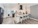 Bright kitchen featuring a marble island with barstool seating, a modern vent hood, and stainless steel appliances at 1599 S Telluride St, Aurora, CO 80017