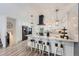 Bright kitchen features a marble island with barstool seating, a modern vent hood, and stainless steel appliances at 1599 S Telluride St, Aurora, CO 80017