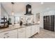 Kitchen features stone counters, stainless appliances, modern range hood, bar stool seating, and open concept at 1599 S Telluride St, Aurora, CO 80017