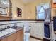 Bathroom features a vanity sink, toilet, and window with natural lighting at 945 Griffith St, Louisville, CO 80027