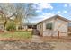 Fenced backyard featuring raised garden beds, a gravel pathway, and lawn area at 3198 W Amherst Ave, Denver, CO 80236