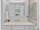 Modern bathroom with a mirrored vanity and glass-enclosed shower at 3198 W Amherst Ave, Denver, CO 80236