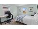 Bright bedroom features two windows, desk area, and a cozy bed with unique patterned blanket at 3198 W Amherst Ave, Denver, CO 80236