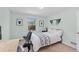 Bright bedroom showcases a bed with work station, complemented by stylish wall decor and natural light at 3198 W Amherst Ave, Denver, CO 80236