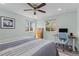 Light-filled bedroom featuring a ceiling fan and modern decor at 3198 W Amherst Ave, Denver, CO 80236