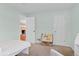Airy bedroom showcasing a view to another room, with ample storage and charming decor at 3198 W Amherst Ave, Denver, CO 80236