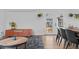 Open-concept dining area with a modern table set, leading to a bright backyard view at 3198 W Amherst Ave, Denver, CO 80236