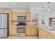 Functional kitchen with stainless steel appliances, tile backsplash, and plenty of counter space at 3198 W Amherst Ave, Denver, CO 80236