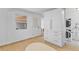 Well-lit laundry room with white cabinets, washer, dryer and tile floors at 3198 W Amherst Ave, Denver, CO 80236