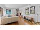 Spacious living room featuring hardwood floors, fireplace, and large windows at 3198 W Amherst Ave, Denver, CO 80236