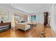 Large living room with hardwood floors, art, and a view to the backyard at 3198 W Amherst Ave, Denver, CO 80236