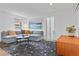 Bright living room with a large sectional sofa, round coffee table, and decorative accents at 3198 W Amherst Ave, Denver, CO 80236